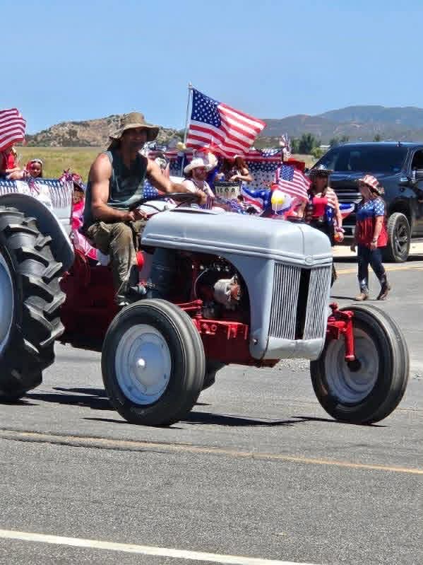 A vintage Ford tractor in the parade